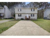 Traditional two-story home featuring a large driveway and a quaint front entrance at 1431 Cherrycrest Dr, Durham, NC 27704