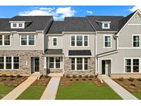 Modern townhomes featuring stone accents, neutral siding, and well-manicured lawns at 1431 Goldsboro Ave, Sanford, NC 27330