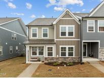 Charming two-story home with gray and tan siding and a well-manicured front yard at 1726 Wimberly Rd, Apex, NC 27523