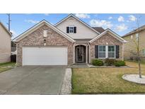 Charming one-story brick home with an attached garage, manicured lawn, and classic architectural details at 1728 Fern Hollow Trl, Wake Forest, NC 27587