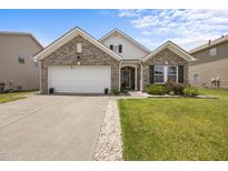 Charming single-Gathering home featuring a brick facade, manicured lawn, and an attached two-car garage at 1728 Fern Hollow Trl, Wake Forest, NC 27587