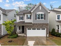Charming two-story home featuring a stone facade and a two-car garage at 1915 Kings Knot Ct, Apex, NC 27502