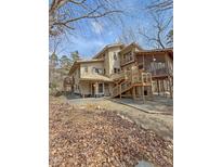 Beautiful multi-level home with wood exterior, multiple decks, and screened-in porch at 2811 Chicken Bridge Rd, Pittsboro, NC 27312
