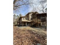 View of the exterior featuring a two-story home with multiple decks and a screened in porch at 2811 Chicken Bridge Rd, Pittsboro, NC 27312