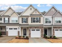 Charming townhomes with stone accents, attached garages and inviting curb appeal at 5 Galway Glenn Ln, Durham, NC 27705