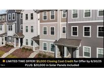 View of townhome exteriors, showcasing a blend of colors and architectural details at 5432 Crescent Square St, Raleigh, NC 27616