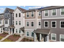 Attractive townhome exteriors showing multi-tonal facades and covered entrances at 5432 Crescent Square St, Raleigh, NC 27616
