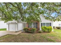 Charming single-Gathering home featuring a brick facade, vinyl siding, and manicured landscaping in a suburban neighborhood at 6308 Saybrooke Dr, Raleigh, NC 27604