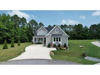 Charming two-story home with landscaped yard, covered porch, and an inviting driveway at 6521 Camellia Creek Dr, Raleigh, NC 27603