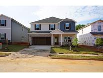 Charming two-story home with a two-car garage and freshly installed sod in the front yard at 721 Deschutes Dr, Garner, NC 27529