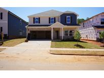 New two-story home featuring an attached two car garage, manicured lawn and neutral color palette at 721 Deschutes Dr, Garner, NC 27529
