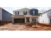 New construction featuring partial brick facade, two-car garage, and charming entry at 721 Deschutes Dr, Garner, NC 27529