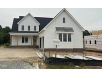 New construction two-story home with white siding, a black roof, and an attached garage under cloudy skies at 1029 Azalea Garden Cir, Raleigh, NC 27603