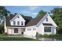 Charming two-story home featuring white siding, a dark roof, manicured landscaping, and an attached two-car garage at 1029 Azalea Garden Cir, Raleigh, NC 27603