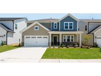 Charming two-story home with a two-car garage, well-manicured lawn, and inviting front porch at 1140 Sun Springs Rd, Wake Forest, NC 27587
