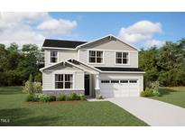Charming two-story home with a manicured lawn, attached two-car garage, and beautiful landscaping at 184 Sprenger St, Garner, NC 27529