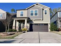 Charming two-story home featuring a spacious two-car garage and manicured front yard at 2123 Gregor Overlook Ln, Apex, NC 27502