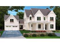 Beautiful two-story home showcasing white siding, dormers, covered porch, and attached two-car garage at 35 Big Bear Dr, Pittsboro, NC 27312