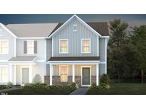 Charming two-story townhome featuring a brick foundation and covered front porch at 357 Fosterton Cottage Way, Raleigh, NC 27603