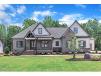 Charming brick home with a manicured lawn and inviting front porch at 3920 Cedar Knolls Drive Dr # 18, Youngsville, NC 27596