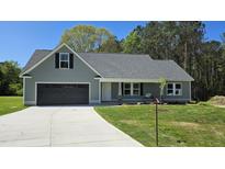 Charming single-Gathering home featuring a two-car garage, well-manicured lawn, and welcoming entrance at 427 Magnolia Run Way, Benson, NC 27504