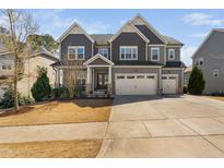 Charming two-story home with a three car garage and beautiful stone accents at 437 Creekhurst Pl, Cary, NC 27519