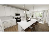 Bright kitchen featuring white cabinets, stainless appliances, and a large island with seating at 520 Folk Song Way, Wendell, NC 27591