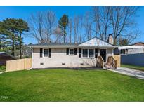 Charming brick home with a well-manicured lawn and inviting front entrance at 6 Hawaii Ct, Durham, NC 27713