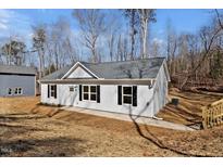 Charming home featuring black shutters, gray roof, and a well-manicured lawn at 604 E Pope St, Dunn, NC 28334