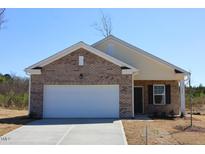 Charming single Gathering home featuring brick and siding facade and an attached two car garage at 7385 Pilatus Ave, Spring Hope, NC 27882