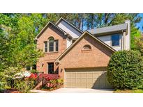 Charming brick home with a two-car garage and mature landscaping at 103 Windhover Dr, Chapel Hill, NC 27514