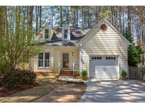 Charming home featuring dormer windows, attached garage, and a manicured lawn at 111 Fox View Pl, Cary, NC 27511
