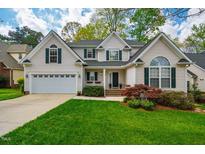 Beautiful two-story home with manicured lawn, attached garage, and decorative shutters at 113 Glenmore Rd, Chapel Hill, NC 27516