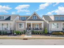 Charming home featuring a cozy front porch and stone accents, set in a welcoming neighborhood at 149 Logbridge Rd, Chapel Hill, NC 27516