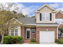 Charming two-story home featuring brick and siding exterior, attached garage, and well-manicured landscaping at 1515 Poets Glade Dr, Apex, NC 27523
