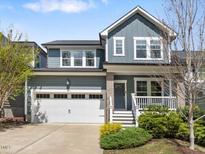 Charming two-story home with a two-car garage, inviting front porch, and manicured landscaping at 173 Hawk Point Rd, Chapel Hill, NC 27516