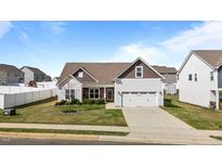 Charming single-Gathering home with a two-car garage, well-maintained lawn, and inviting curb appeal at 205 Mcclellan Trl, Mebane, NC 27302
