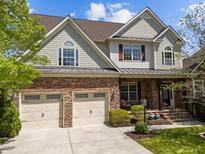 Charming home with a two-car garage, stone accents, and a welcoming front porch at 224 Clear River Pl, Cary, NC 27519