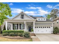 Charming home featuring a covered porch with white columns and manicured landscaping at 2321 Swansea Ln, Apex, NC 27502