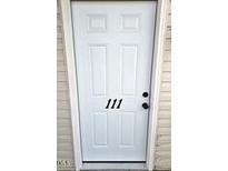 White front door with the number 111 in black numbers centered on the door at 3015 Winston Dr # 111, Burlington, NC 27215