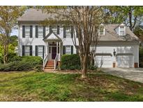 Charming two-story home with white siding, dark shutters, and a well-maintained front yard at 3308 Churchill Rd, Raleigh, NC 27607
