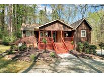 Charming home with a welcoming front porch, nestled in a wooded setting at 3508 Cole Mill Rd, Durham, NC 27712