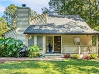 Charming home with a welcoming front porch, stone walkway and mature landscaping at 3900 Maplefield Dr, Raleigh, NC 27613