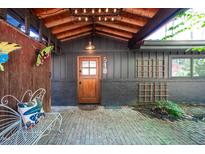 Inviting front entrance features a brick patio and unique details, creating a welcoming ambiance at 518 Morgan Creek Rd, Chapel Hill, NC 27517