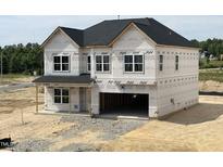 Unfinished two-story home with large windows and attached two-car garage at 705 Compeer Way # 31, Rolesville, NC 27571