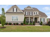 Beautiful two-story home with stone accents, covered porch, manicured lawn and tasteful landscaping at 7825 Green Hope School Rd, Cary, NC 27519