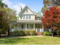 Charming two-story home with a welcoming front porch and well-manicured landscaping at 104 Glenview Pl, Chapel Hill, NC 27514