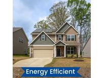 Charming two-story home featuring a well-maintained lawn and solar panels for energy efficiency at 108 Pronghorn Deer Ct, Garner, NC 27529