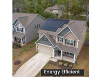 Two-story home boasting solar panels, landscaped yard, and a neutral color palette at 108 Pronghorn Deer Ct, Garner, NC 27529