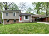 Charming two-story home with a red front door, well-maintained lawn, and covered parking at 1105 Terrace Ct, Raleigh, NC 27615